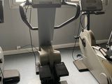 three stationary exercise bikes in a room with a window