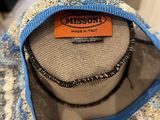 the back of a blue and white sweater with a label on it