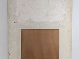 painting on the wall of a room with white walls and a brown door