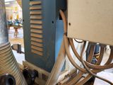 a machine that is working on a piece of wood