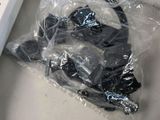 a bag of headphones sitting on a table next to a remote control