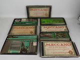 five boxes of meccano cigarettes are lined up on a white surface