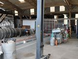 an image of a garage with a lot of tires on the floor