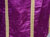 a close up of a purple and gold dress on a mannequin dummy