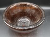 a glass bowl that is sitting on top of a table