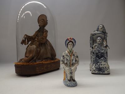 three figurines sitting under a glass dome on a table