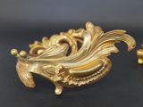 a gold plated object on a black surface