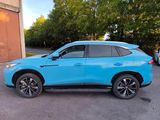 a blue suv parked in a parking lot next to a building