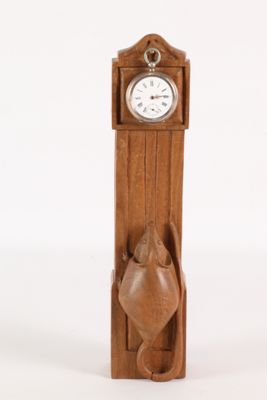 a wooden clock with a cat on the front of it