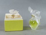 a small glass vase with a flower inside of it
