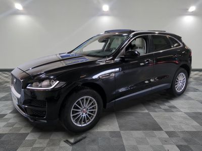 the black jaguar suv is parked on a checkered tile floor