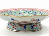 a bowl with a floral design on it on a white surface