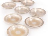 six silver plated bowls and a bowl on a white surface
