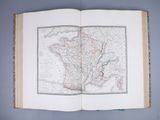 an open book with a map on it on a table