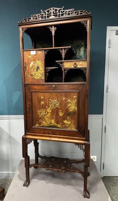 une vieille armoire en bois ornée d'un motif floral sur la façade