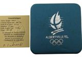 une image représentant une pièce de monnaie et un billet sur lequel figure le logo olympique