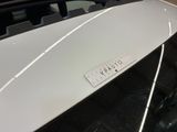 a close up of a white car with a sticker on it ' s hood