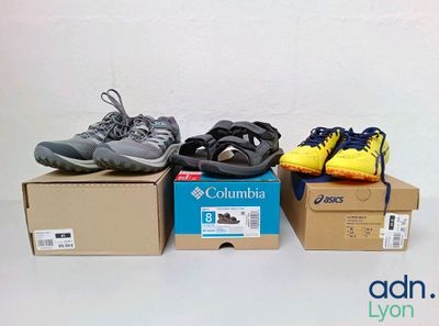 three pairs of shoes sitting on top of a box