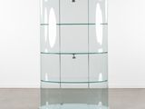 a glass display case with a key on the floor