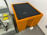 a yellow trash can next to a black trash can