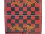 a red and black checkered box with a dragon design on it