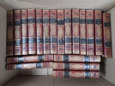 an open box filled with lots of books sitting on top of a table