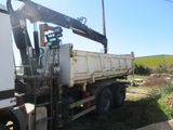 a white truck with a crane on the back of it