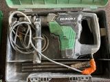 a box with a drill and other tools inside of it