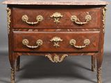 an antique chest of drawers with a marble top