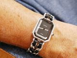 a man wearing a watch on his wrist with a chain around his wrist