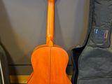 a guitar sitting next to a guitar case on the floor