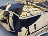 a close up of a purse with a chain on it
