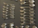 many spoons and spoon spoons arranged on a wall