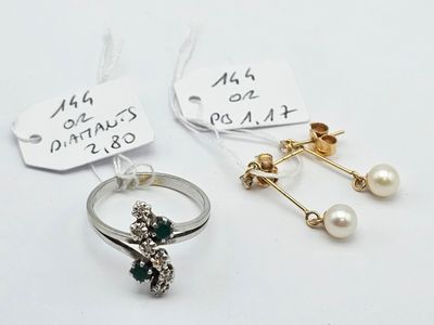 two rings and a pair of earrings are on a white surface