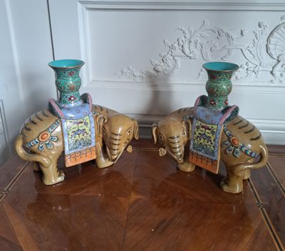 two vases that are sitting on top of a wooden table