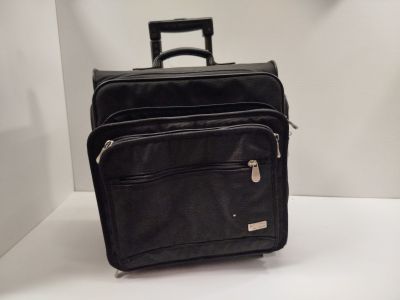 a black piece of luggage sitting on a white surface