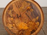 a wooden plate with a floral design on it