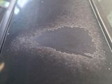 a black car that has a hole in the hood