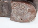 a close up of a pair of shoes with holes in the sole