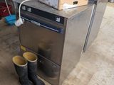 a pair of boots sitting on the floor next to a stove