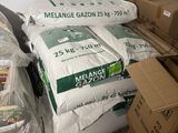 many bags of food sitting on a bed in a room