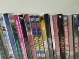 a lot of dvd ' s on a shelf on the wall