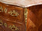a marble top chest of drawers in a room
