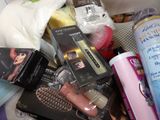 a pile of beauty products sitting on top of a bed