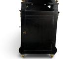 an image of a small black clock with a key on it