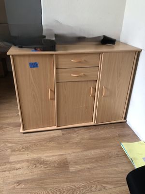 a tv that is sitting on top of a wooden cabinet
