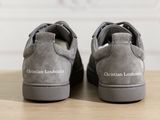 someone is wearing a pair of grey shoes with the word christian loubouti on them