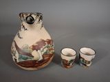 a picture of a pitcher and two cups on a table