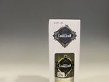 a white box sitting on top of a table next to a bottle of alcohol