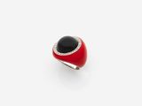 a close up of a red and black ring on a white surface